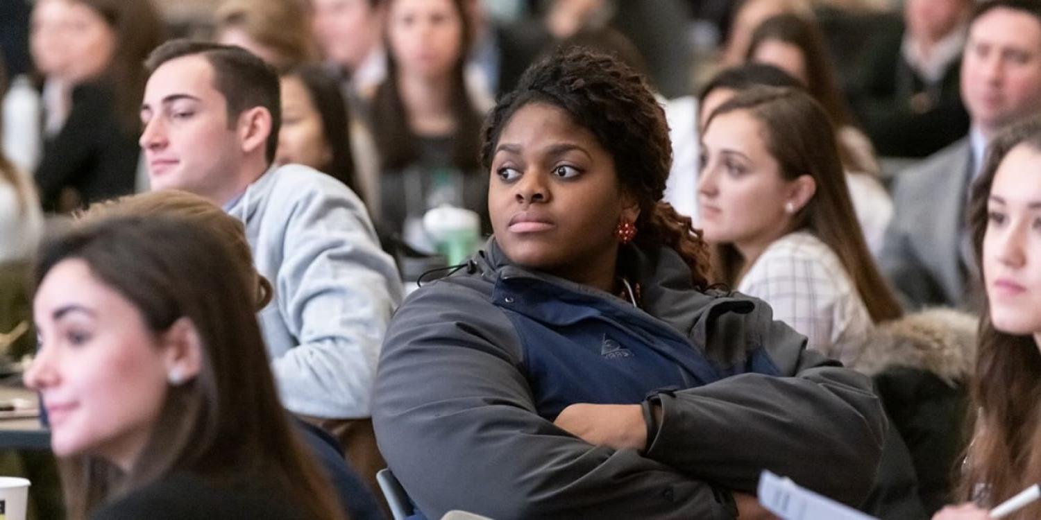 woods students at tables during a research conference