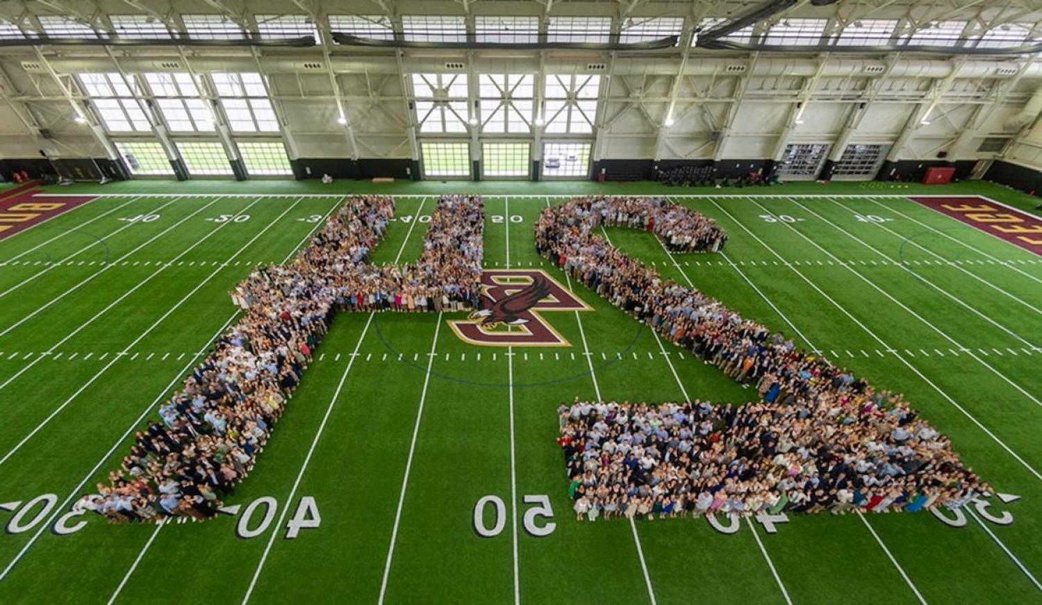 Members of the senior class pose in the shape of the number 24