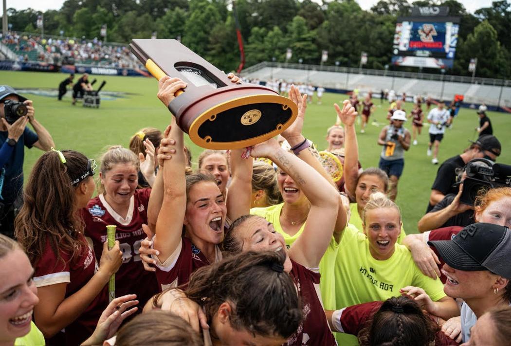 women's lacrosse team with championship tropht